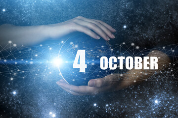 October 4th. Day 4 of month, Calendar date. Human holding in hands earth globe planet with calendar...