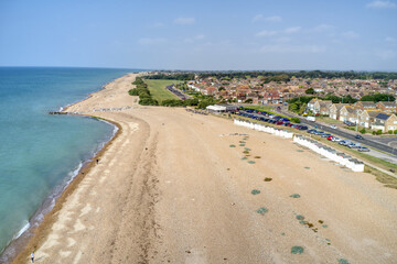 Goring by Sea beach with the Sea Lane Cafe in view and the greensward behind the beach at this popular seaside resort. Aerial photo.