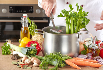 Chef preparing ingredients for soup or hotpot in a saucepan