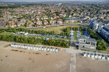 Yacht Club with beach huts in view along the Goring by Sea seafront. Aerial view.