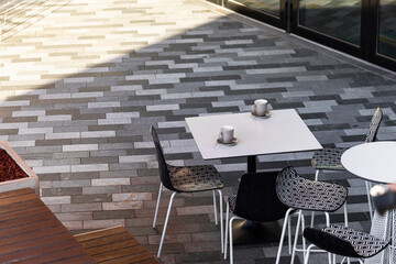 Cafe table with empty cups left behind.