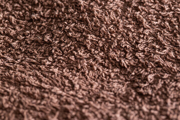 Brown terry towel, background, close-up. handicrafts