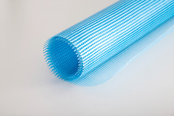 Blue reinforcing construction mesh for wall strengthening on white background, isolate. Close-up