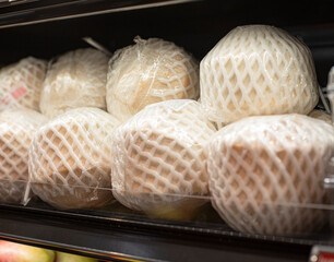 Peeled and packaged coconuts in a supermarket