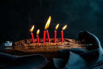 Freshly baked chocolate birthday cake with candles in a glass baking dish
