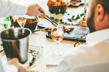 Waiter Serving Wine In The Restaurant