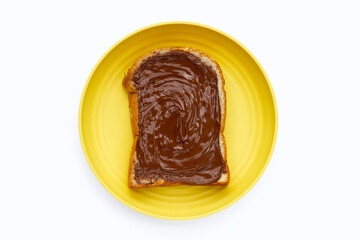 Bread with sweet chocolate hazelnut in yellow plate on white