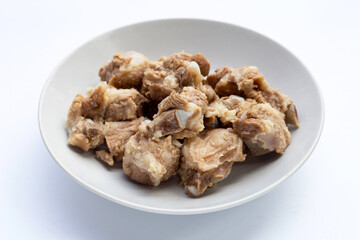 Boiled pork ribs in white plate on white background.