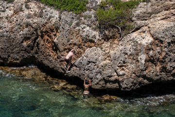 young people jumping into the water, Cala Beltran, Llucmajor, Mallorca, Balearic Islands, Spain