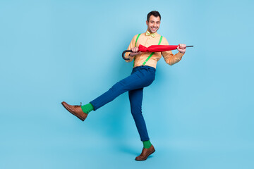 Full body photo of brunet man with parasol dance wear shirt trousers socks shoes isolated on blue color background