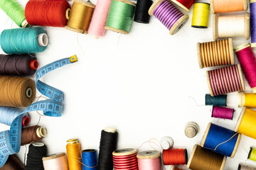 Sewing threads, needles and tape measure, copy space