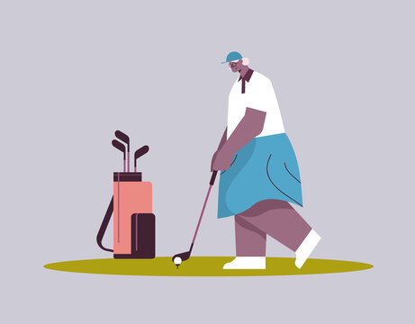 senior woman playing golf aged african american female player taking a shot active old age concept