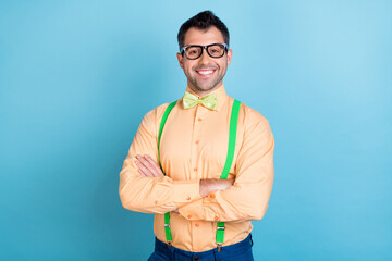 Photo of self-assured businessman crossed arms wear green suspenders shirt bow tie isolated blue...