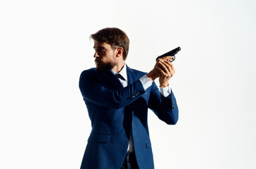 Man with a pistol in hand crime detective killer light background