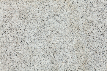 Granite stone texture background with a mottled black and white spotted textured effect with a blank surface for copy space, stock photo image