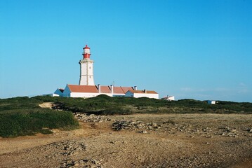 Fototapeta na wymiar lighthouse on the coast. light house on the shore of a portugal cliff