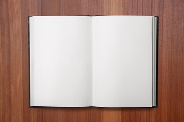 Open blank notebook on a wooden desk