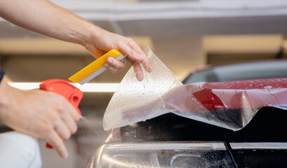 Concept of installing protective transparent vinyl film to protect paint and varnish of car