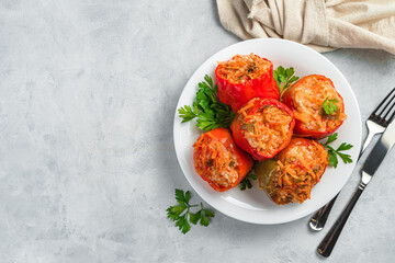 Bulgarian pepper stuffed with meat, vegetables and rice on a gray background. Healthy food.