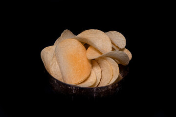 Potato chips on a black background. Close-up
