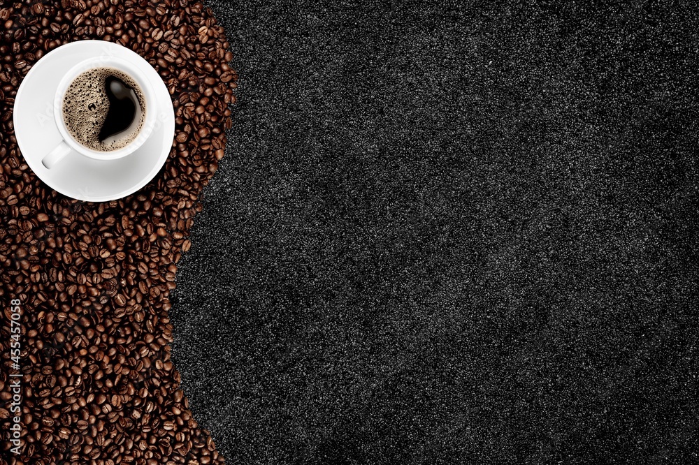 Wall mural black hot coffee with foam in a white ceramic cup with coffee beans