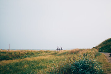 Dutch tourism in The Netherlands - bicycles and silhouettes in beautiful nature of Terschelling...