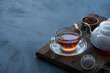 Obraz na płótnie Canvas Hot tea in a glass teapot and cup
