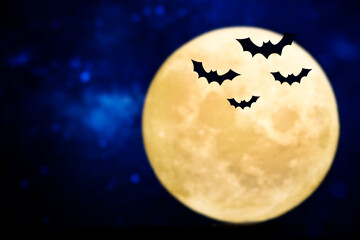 Bats flying silhouette over a full moon