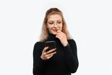 Image of a thoughtful young beautiful woman in casual clothes holding her smart phone. White background