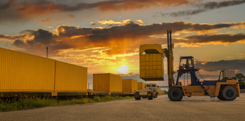 Forklift truck is lifting cargo containers at a train station,railway waiting for distribution...