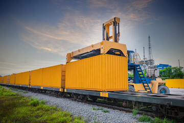 Forklift truck is lifting cargo containers at a train station,railway waiting for distribution...