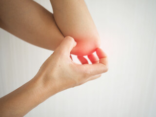 Asian woman has dry skin and scratching her elbow. closeup  photo, blurred.