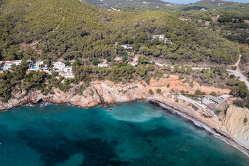 Aerial photo of the Spanish island of Ibiza showing the beautiful beach front at Cala Sol d'en Serra in the summer time in the Balearic Islands, Spain.