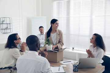 Group of coworkers welcoming new employee in team indoors