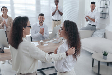 Boss introducing new employee to coworkers in office