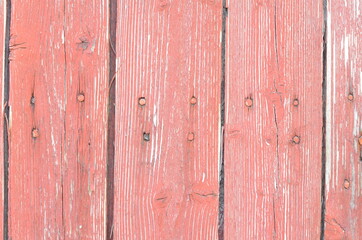 Background from planed red boards with nails.