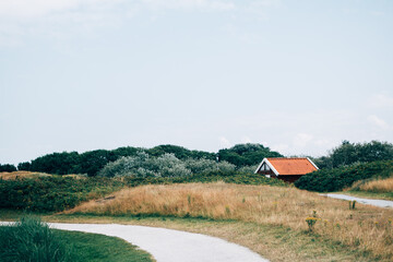 Little holiday house on Dutch Wadden island Ameland next to scenic nature hike path