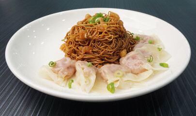 stir fried dry wanton noodle mee with meat dumpling on dark grey wood background dim sum halal menu