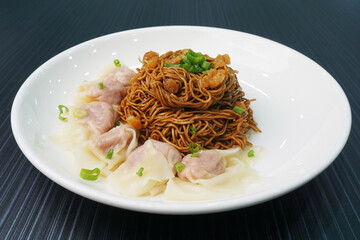 stir fried dry wanton noodle mee with meat dumpling on dark grey wood background dim sum halal menu