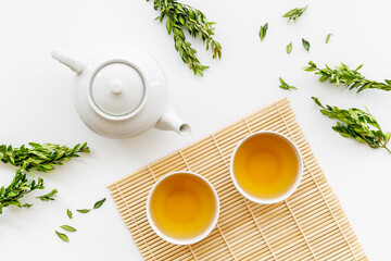Asian tea set with white teapot and two cups, top view