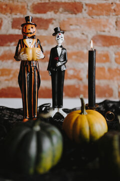 Pumpkin man and a skeleton statue
