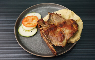 bbq baked grilled pork chop steak meat on dark grey wood background dim sum halal menu