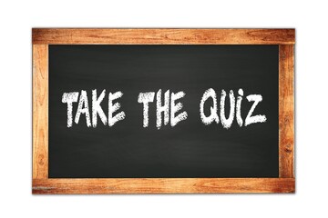 TAKE  THE  QUIZ text written on wooden frame school blackboard.