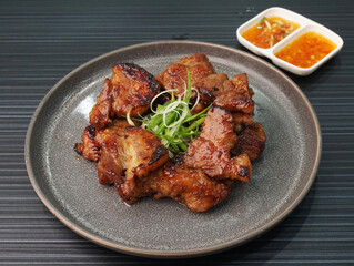 bbq grilled tender pork chop meat with sauce on dark grey wood background dim sum halal menu
