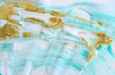 art photography of abstract marbleized effect background with gold, mint, blue and white creative colors. Beautiful paint.