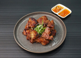 bbq grilled tender pork chop meat with sauce on dark grey wood background dim sum halal menu