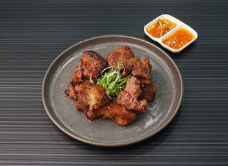 bbq grilled tender pork chop meat with sauce on dark grey wood background dim sum halal menu