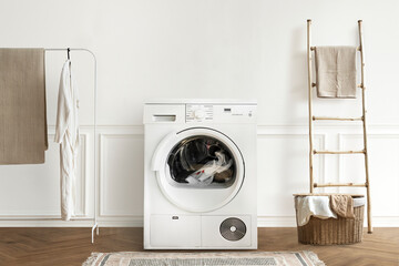 Washing machine in a minimal laundry room interior design - obrazy, fototapety, plakaty