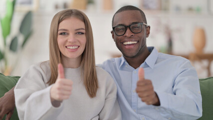 Positive Interracial Couple showing Thumbs Up, Home