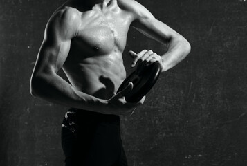 Fototapeta na wymiar male athletic physique cropped view muscle dark background